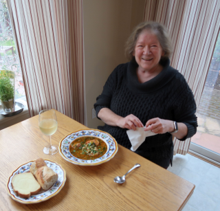 Robin sitting down to enjoy a new favorite she made: Lemony Shrimp & Bean Stew